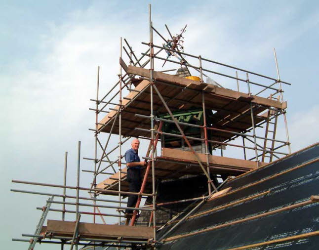 The roof vent with scaffolding, the finial removed from the top for repair.