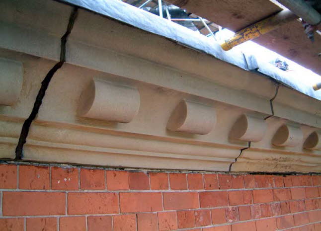 The stonework that supports the roof gutters